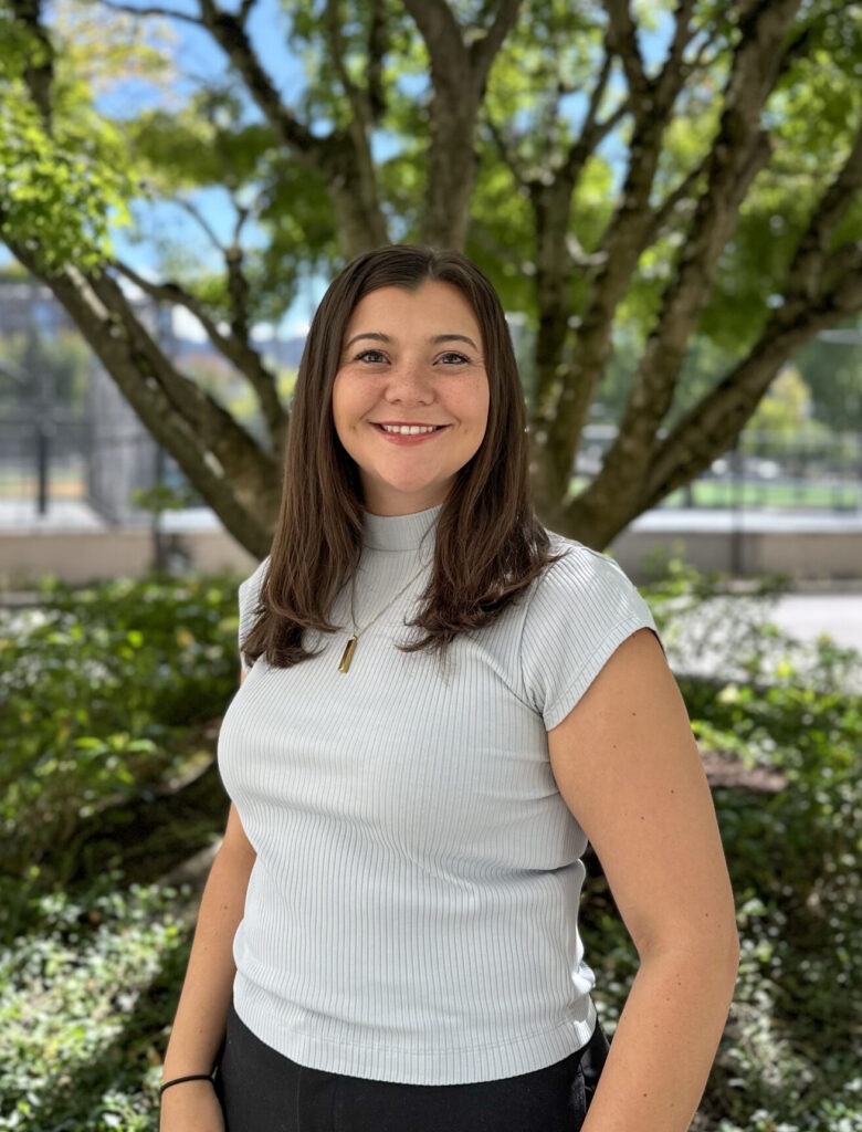 Portrait Photo of Brigitt Harmon, Assistant Community Manager of the Broadway Building. Standing in front of a blurred background.